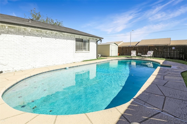 view of pool with a storage shed