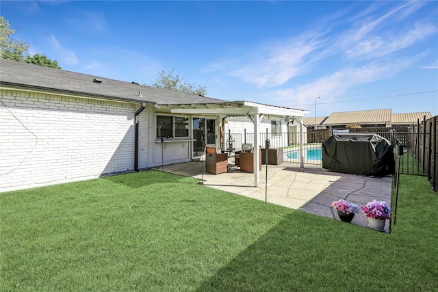 rear view of property with a lawn and a patio area