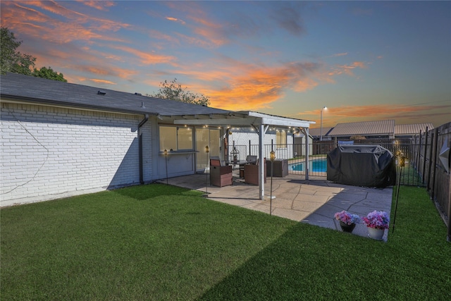 yard at dusk with a fenced in pool and a patio