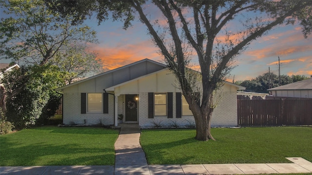 view of front of property with a lawn