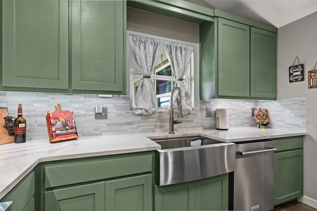 kitchen featuring stainless steel dishwasher, sink, decorative backsplash, and green cabinetry