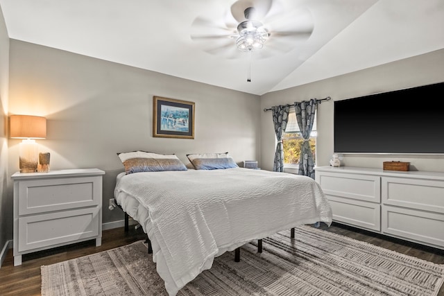 bedroom with ceiling fan, dark wood-type flooring, and vaulted ceiling