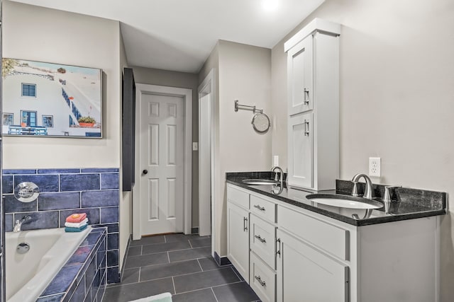 bathroom with vanity, tiled bath, and tile patterned floors