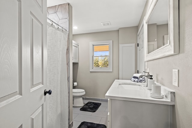 bathroom with toilet, walk in shower, vanity, and tile patterned flooring