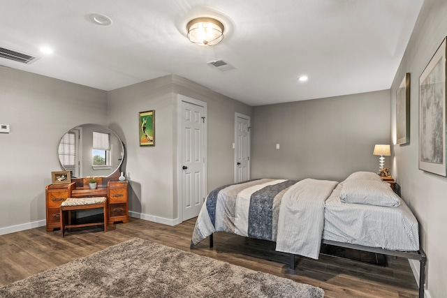 bedroom with dark wood-type flooring