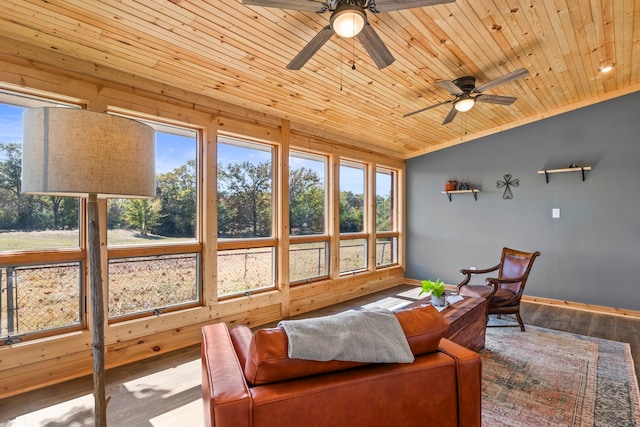 sunroom / solarium with ceiling fan, a wealth of natural light, and wood ceiling