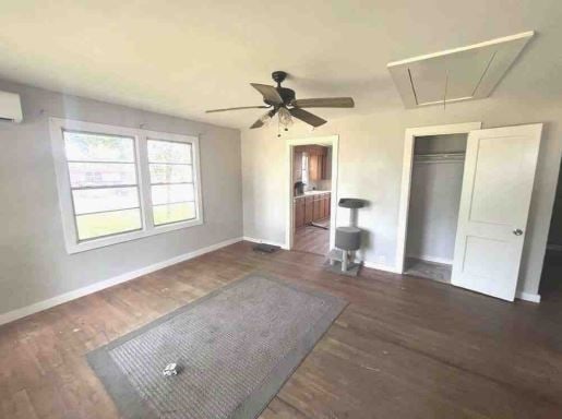 interior space with dark hardwood / wood-style floors, a closet, and ceiling fan