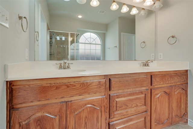 bathroom with a shower with door and vanity