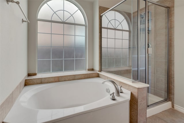 bathroom with shower with separate bathtub