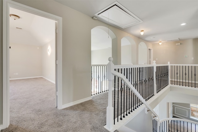 hallway with light colored carpet