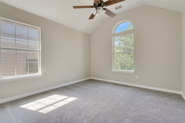 carpeted empty room featuring ceiling fan, a healthy amount of sunlight, and lofted ceiling