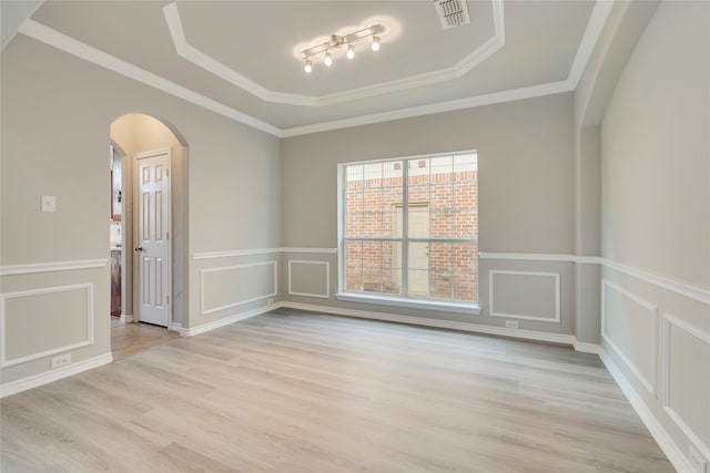 unfurnished room featuring light hardwood / wood-style floors, crown molding, and track lighting