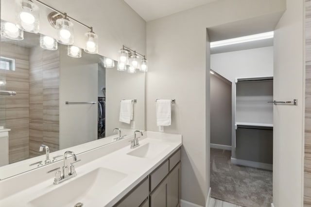 bathroom featuring vanity and tiled shower