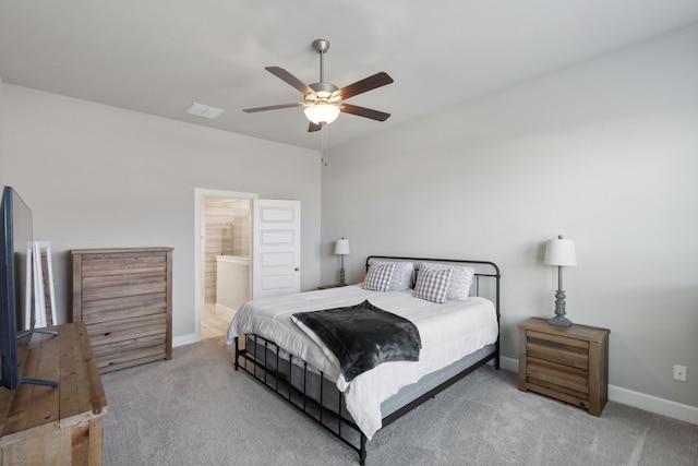 carpeted bedroom with connected bathroom and ceiling fan