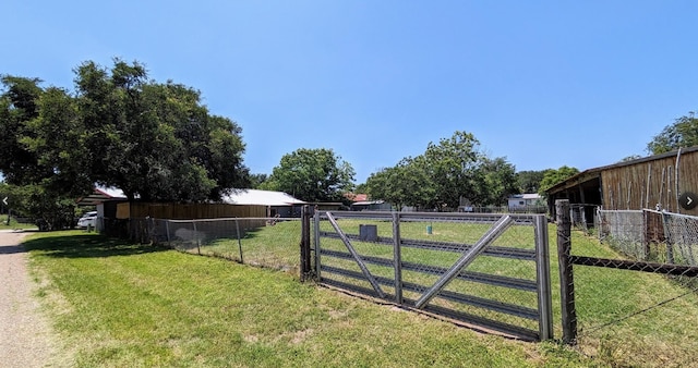 view of gate with a lawn