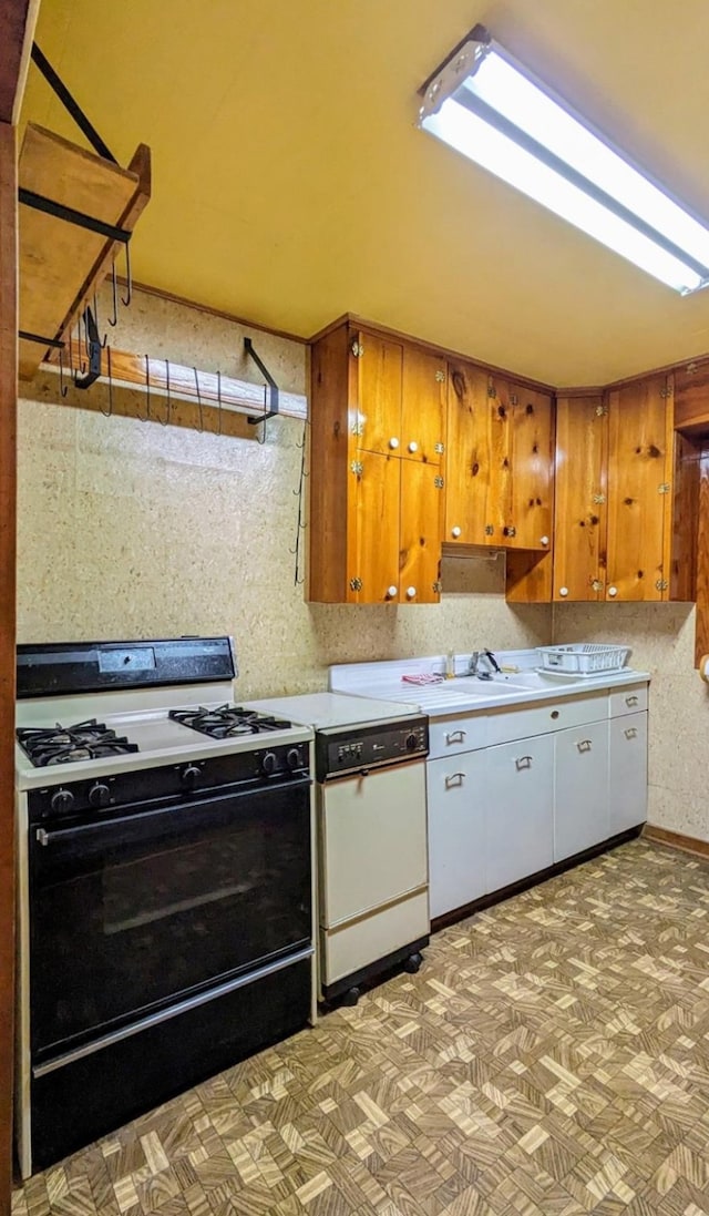 kitchen with lofted ceiling, sink, dishwasher, and black gas range