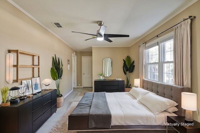 bedroom with light wood-type flooring, ceiling fan, and ornamental molding