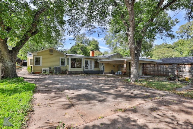 view of front of property with a carport and cooling unit