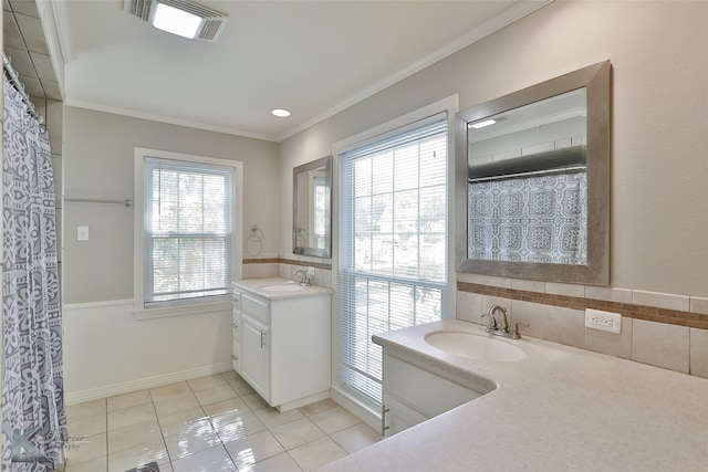 bathroom with tile patterned floors, crown molding, and vanity