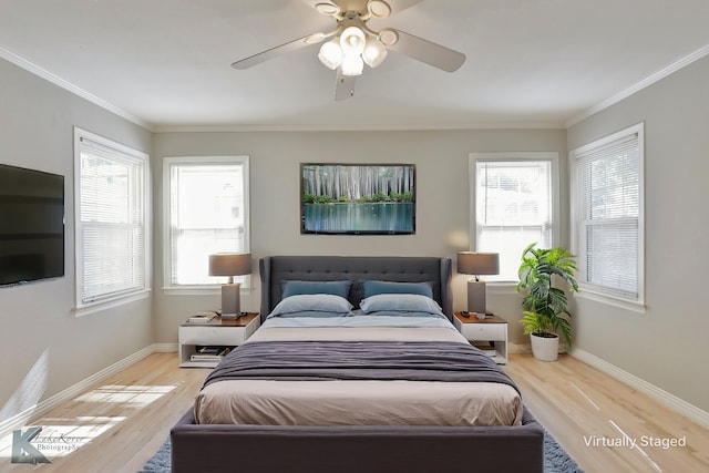 bedroom with light hardwood / wood-style floors, ceiling fan, and ornamental molding