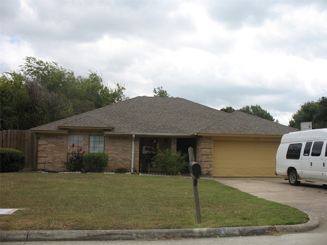 ranch-style home with a front lawn and a garage