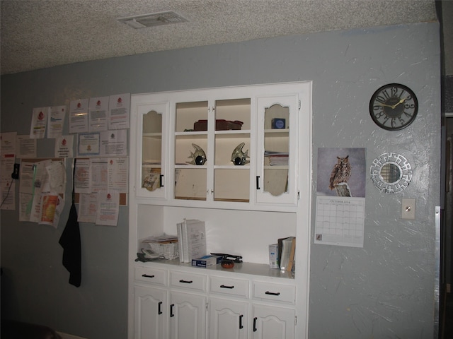 room details with fridge and a textured ceiling