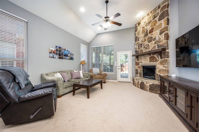 living room featuring light colored carpet, high vaulted ceiling, a fireplace, and ceiling fan