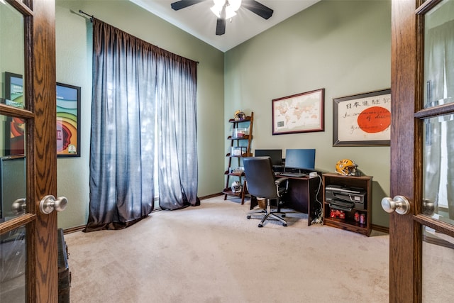 office with french doors, light carpet, and ceiling fan