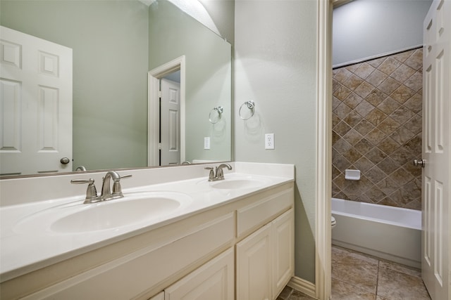 full bathroom featuring vanity, toilet, tiled shower / bath combo, and tile patterned floors