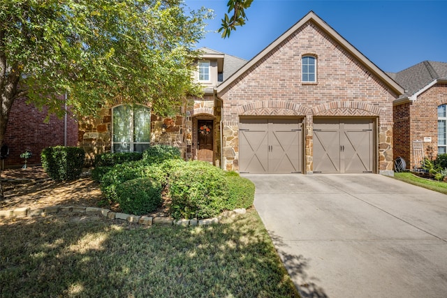 view of front of property featuring a garage and a front lawn