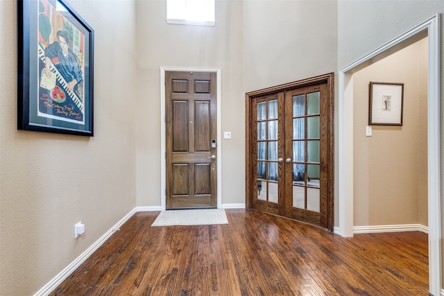 entrance foyer with french doors, dark hardwood / wood-style flooring, and a high ceiling