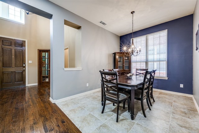 dining room with hardwood / wood-style flooring and a chandelier