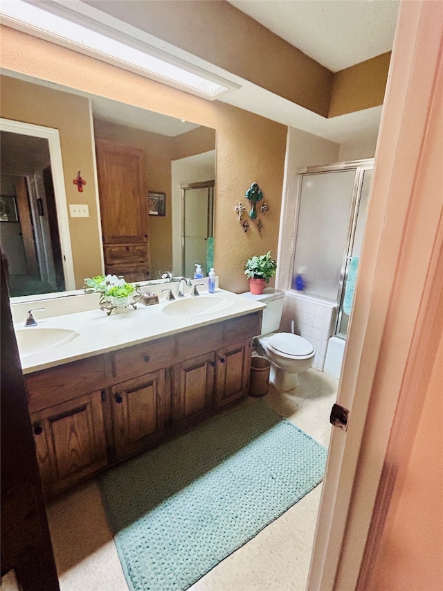 bathroom with vanity, toilet, and walk in shower