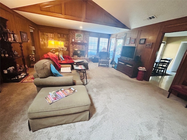 carpeted living room featuring lofted ceiling, a fireplace, and wood walls