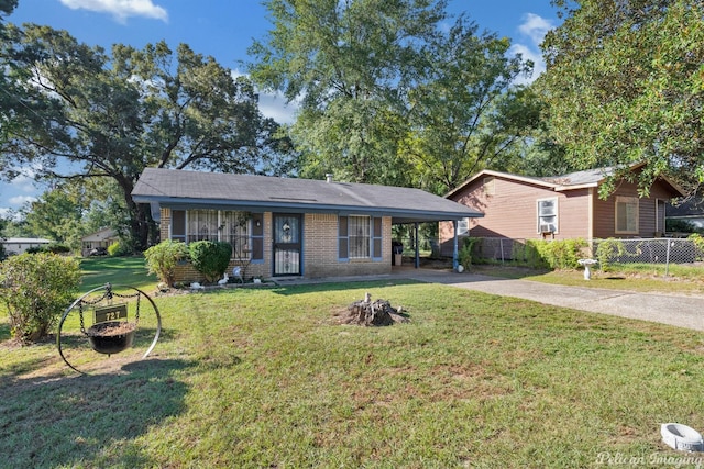 single story home featuring a porch, a front lawn, and a carport