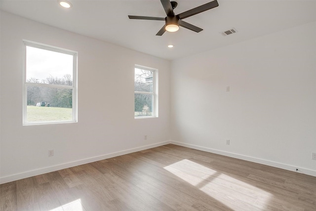 spare room featuring ceiling fan and light hardwood / wood-style flooring