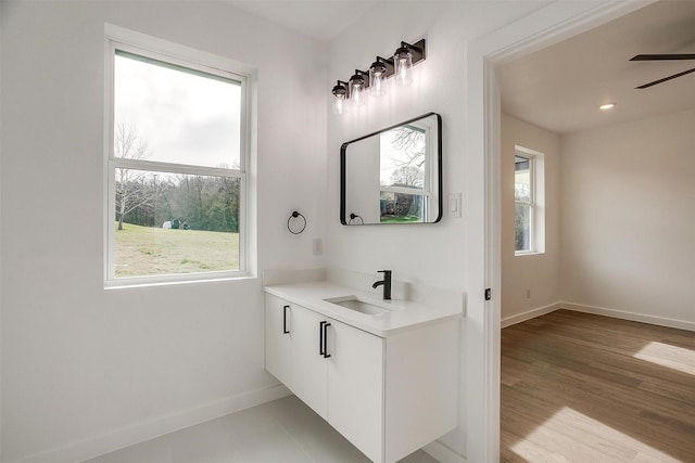 bathroom with ceiling fan, hardwood / wood-style floors, and vanity