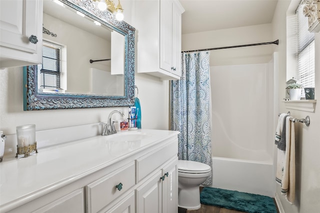 full bathroom with toilet, shower / bath combo with shower curtain, and vanity