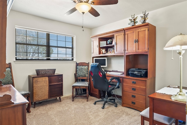 office area with light carpet and a ceiling fan