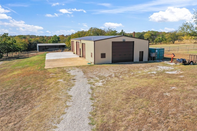 view of outdoor structure with a rural view and a garage