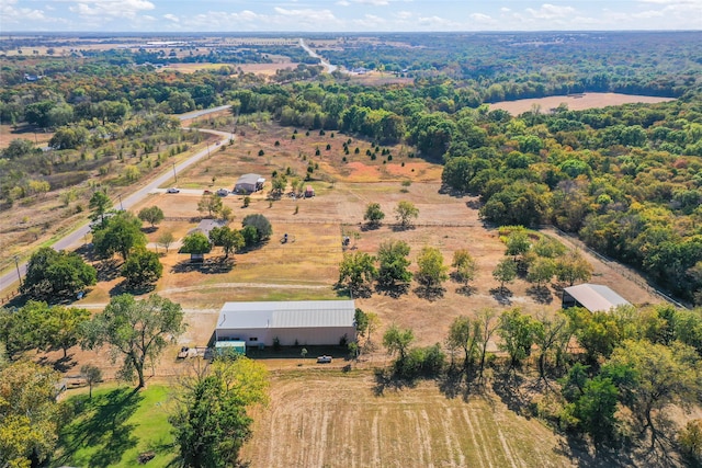 birds eye view of property with a wooded view and a rural view