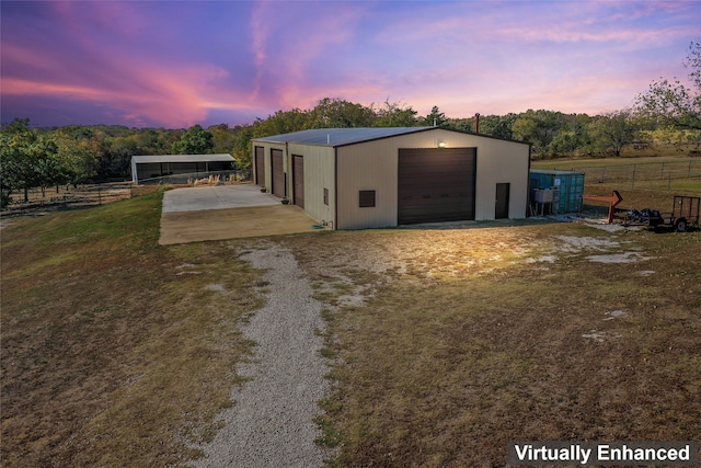 exterior space with an outbuilding, fence, and driveway