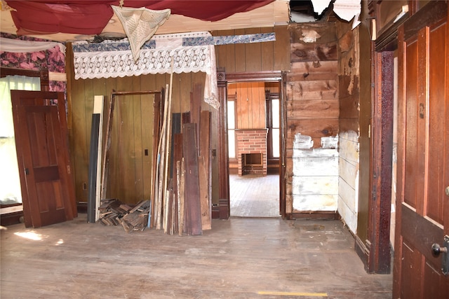 misc room featuring wooden walls and dark hardwood / wood-style floors