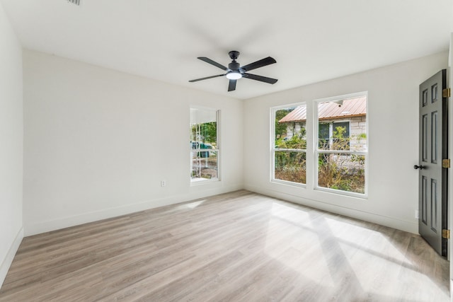 empty room featuring light hardwood / wood-style flooring and ceiling fan