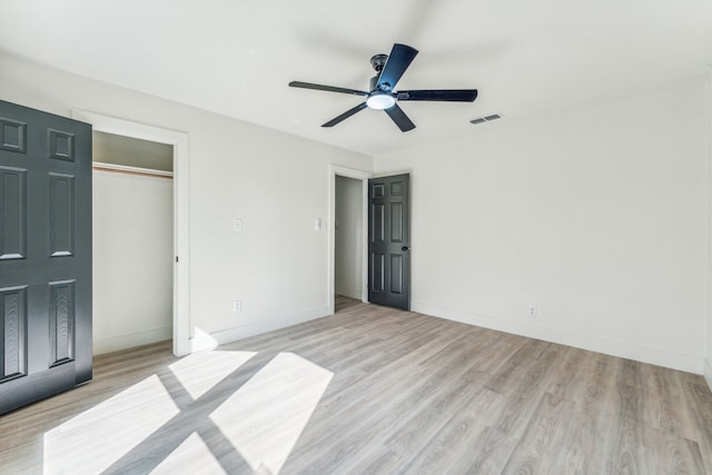 unfurnished bedroom featuring a closet, light hardwood / wood-style floors, and ceiling fan