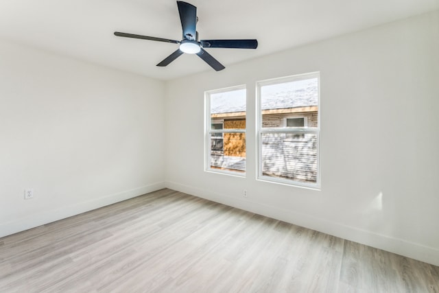 empty room featuring ceiling fan and light hardwood / wood-style floors