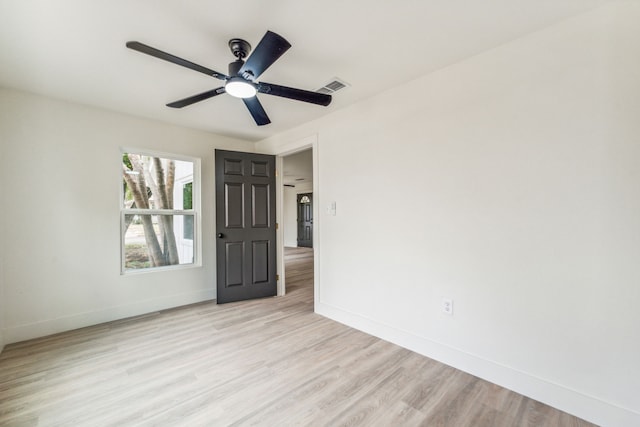 spare room featuring ceiling fan and light wood-type flooring