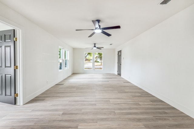 empty room with light wood-type flooring and ceiling fan