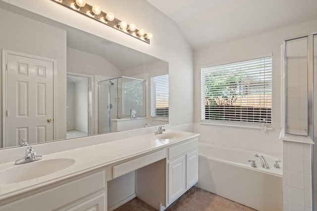 bathroom with vaulted ceiling, a sink, a shower stall, and a bath