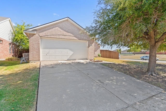 view of side of home featuring a garage and a lawn